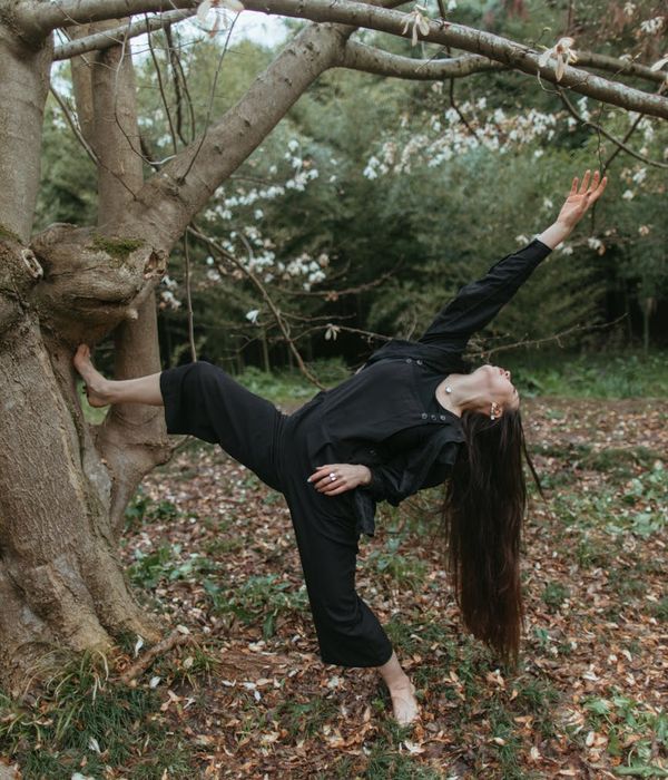 Woman performing a strong yoga pose in a calm environment.
